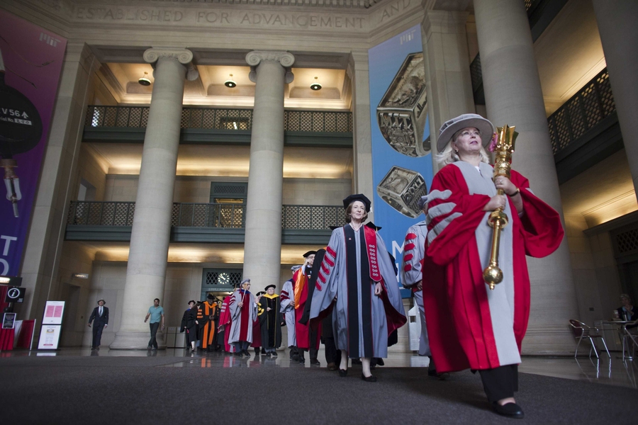 The academic procession begins, with administrators coming through Lobby 7.
