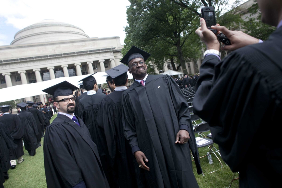 A graduate has his picture taken during the Commencement ceremony.
