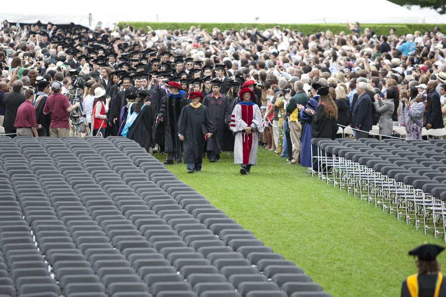The graduates file into Killian Court, led by Dean for Undergraduate Education Daniel Hastings, right, and Dean for Student Life Chris Colombo.