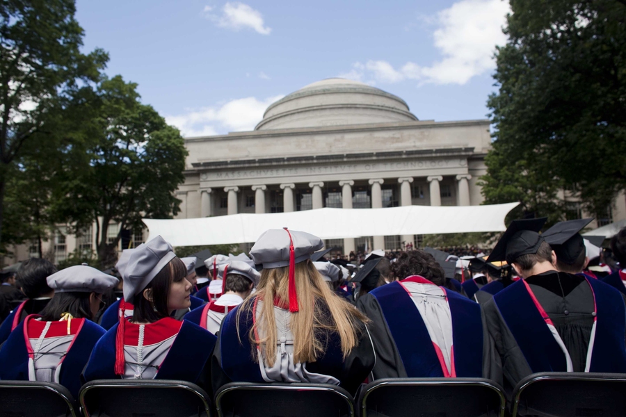 Graduates wait for the exercises to begin, proudly displaying their new hoods.