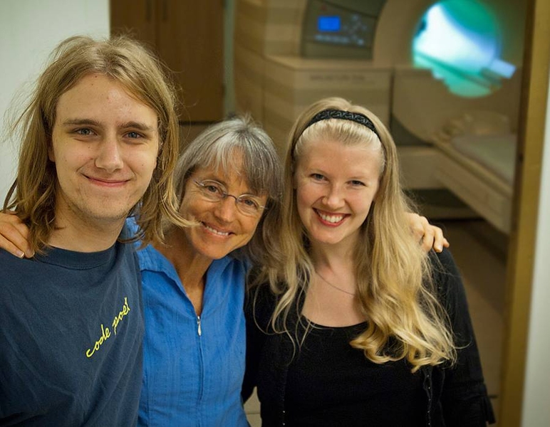 From left, MIT undergraduate Michael Behr, principal investigator Nancy Kanwisher and research scientist Evelina Fedorenko in front of the fMRI machine they use to measure real-time brain activity associated with language and other cognitive tasks.