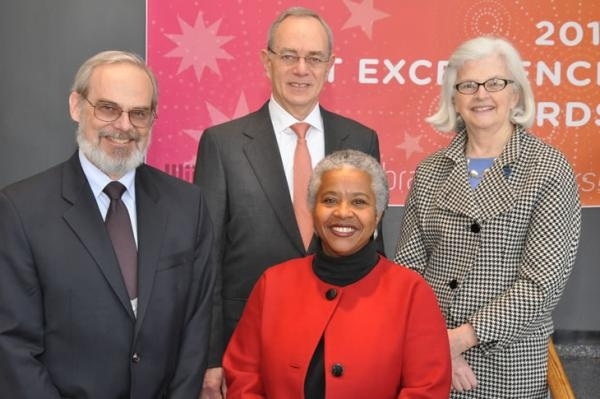 Alyce Johnson, front, poses with Chancellor Eric Grimson, left, Provost L. Rafael Reif, center, and Executive Vice President and Treasurer Theresa Stone after winning a Fostering Diversity and Inclusion award in 2011.