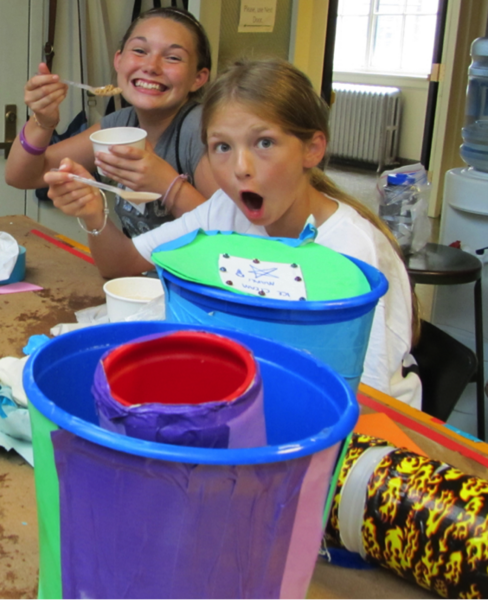 With their ice cream makers that they designed and built in the foreground, these girls enjoy the sweet results of their labors.