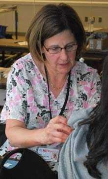 Linda Pasciuto, R.N., administers a flu shot at MIT Medical's Oct. 24, 2011 flu vaccination clinic.
