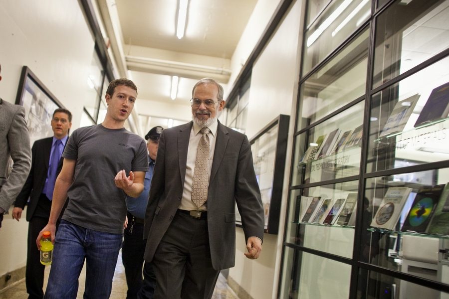Zuckerberg talks with Chancellor Eric Grimson as they walk down the Infinite Corridor.