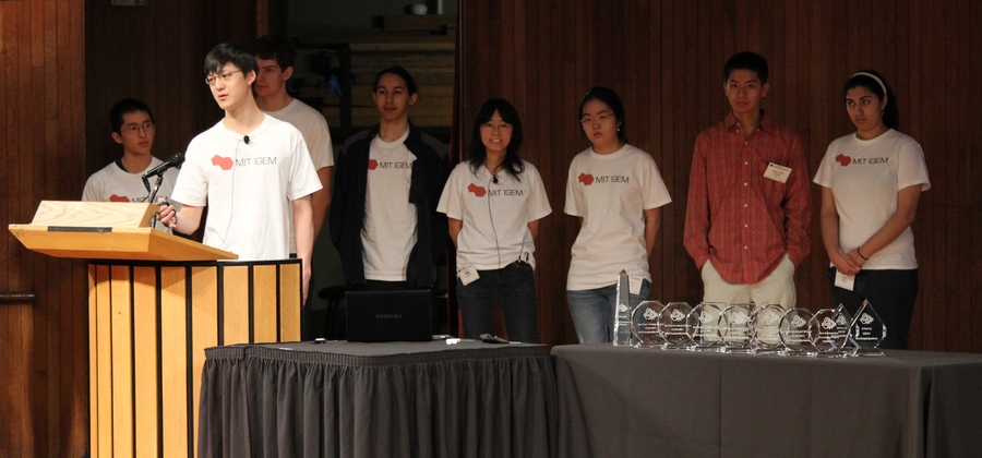From left to right (background): Charles Hsu, Semon Rezchikov, Grant Robinton, Jenny Cheng, Clara Park, Jonathan Chien, Divya Arcot; presenting, Kenneth Hu.