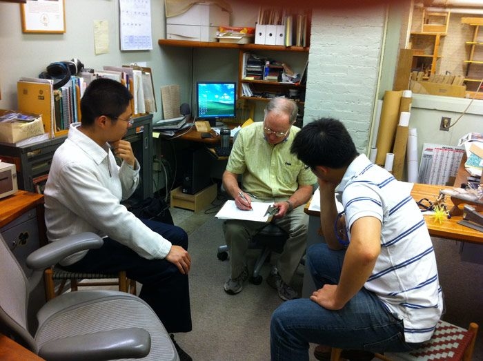 SUTD assistant professors Chen Lujie (left) and Shaohui (right) absorb Stone’s extensive knowledge.