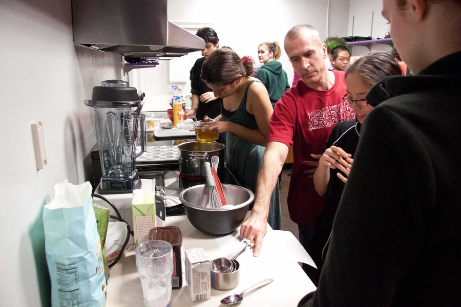 Bon Appétit chef Brian McCarthy shows students vegan cooking techniques during a class in the East Campus dormitory.