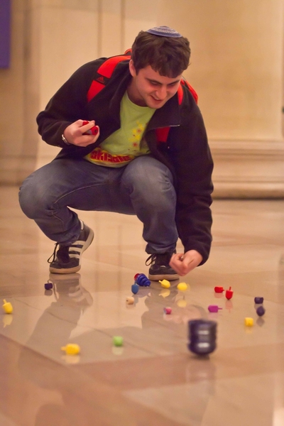 Just missing a world record, freshman Stevie Fine attempted to simultaneously spin as many dreidels as possible.