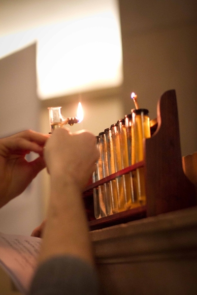 Stauber lights the first candle, which signals the first night of Hanukah, with fellow senior Jason Strauss.