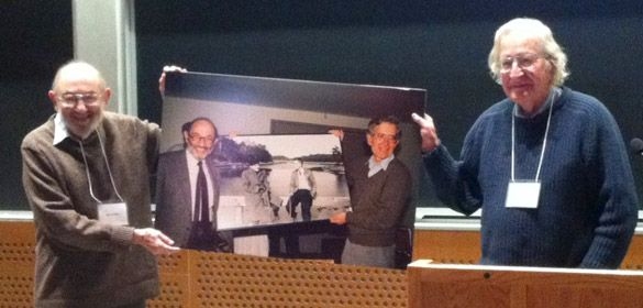 Morris Halle and Noam Chomsky in 2011, holding a 1988 picture of them holding a picture taken of them in 1951. On the occasion of the Scientific Reunion, 50 Years of Linguistics at MIT, December 9-11, 2011.