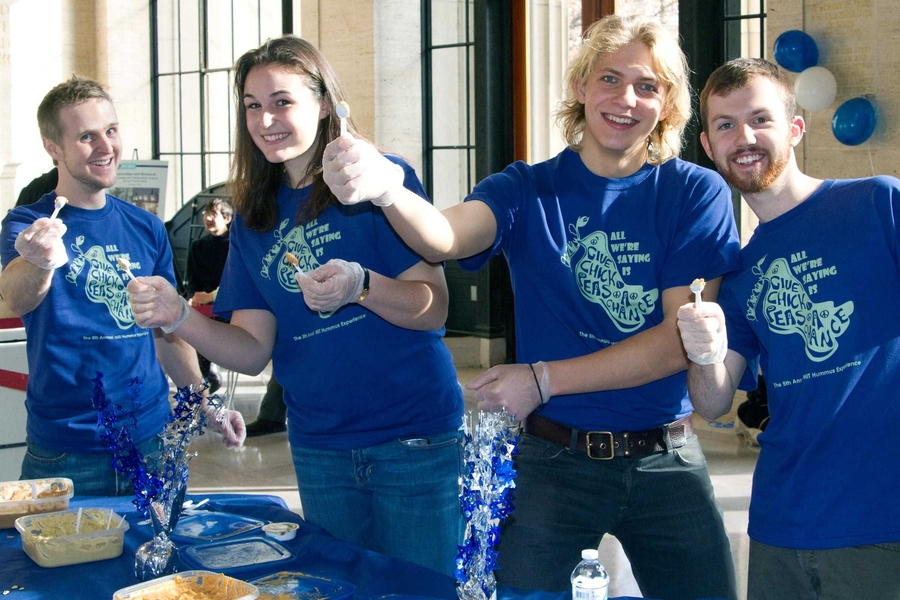 Chris Bolin (graduate student in mechanical engineering), sophomore Maddy Wharton, and freshmen Alex Lis and Dennis Wilson offer smiles and samples of their hummus to tasters.