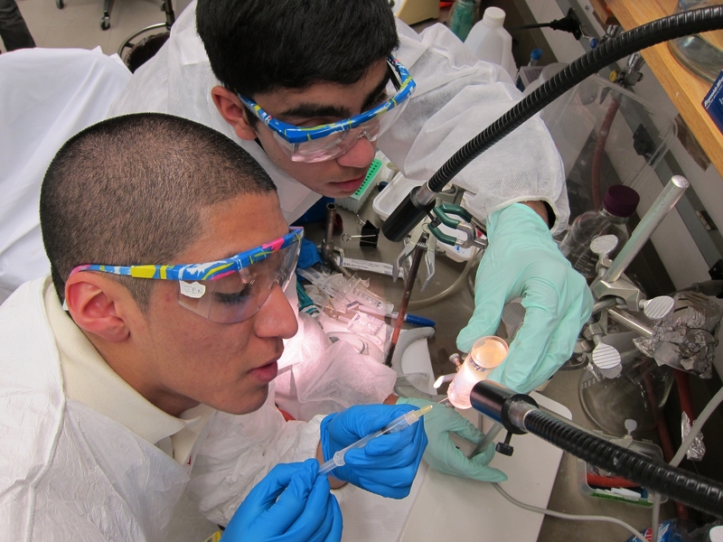 Team members Jonathan Calderon and Jaaron Botello extracting purified phage particles after ultracentrifugation through a cesium chloride gradient.