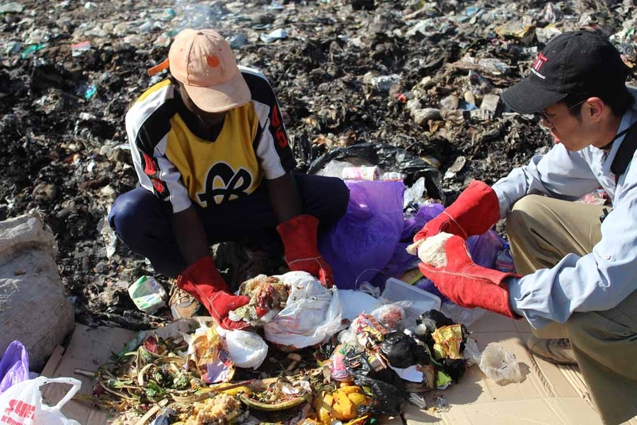 Graduate student Kevin Kung, right, sorted through trash with a waste collector outside of Nairobi, Kenya, over Independent Activities Period (IAP). Kung’s IDEAS Global Challenge team, Takachar, is developing efficient ways to produce charcoal from common household organic waste, such as maize husks and other food products.