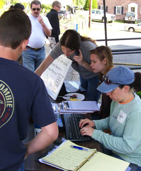 Surrounded by local disaster relief volunteers, Morgan and Caitria O’Neill, center, began developing recovers.org, an innovative recovery platform, last summer in the wake of a tornado that ravaged their hometown — and their own home — in western Massachusetts.