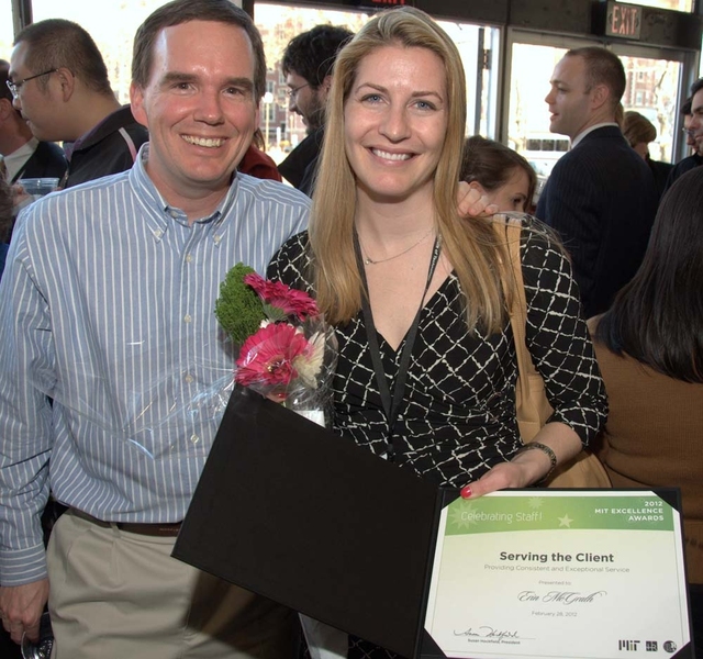 Erin McGrath, recipient of the Serving the Client Award, shows her certificate at the reception following the ceremony.