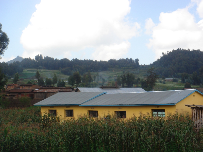 A clinic in the village of Bisate, Rwanda, the yellow building in foreground, was equipped with storage tanks to collect rainwater for use during the area's dry seasons. The corrugated metal roof was fitted with gutters to carry the water to several large collecting tanks, using a 'first-flush' diversion system to separate out the first, dirty water at the beginning of each rainfall.