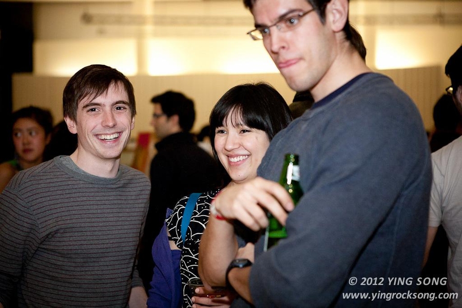 Students look at artwork at the Grad Arts Soiree