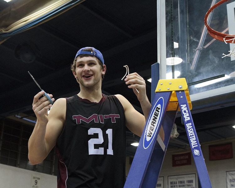 Junior Will Tashman takes his turn cutting down the net after MIT clinched its berth in the NCAA Div. III Final Four. 