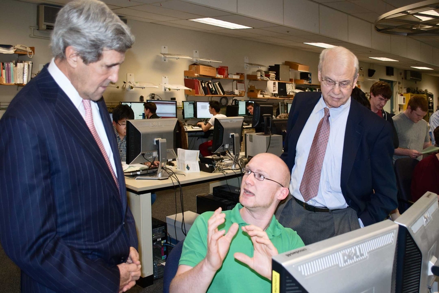 Kerry asks Alcator visiting graduate student Ralph Kube about his research on tokamak plasmas, as PSFC Director Miklos Porkolab watches.