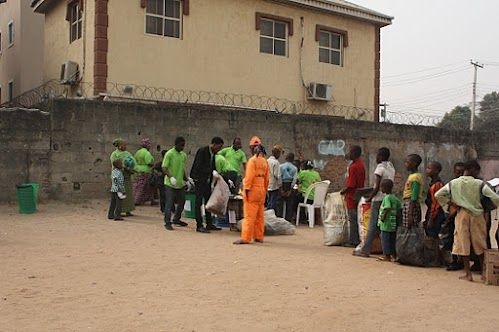 Participants line up to drop off their recyclables to be sorted in exchange for noodles, phone recharge cards and raffle tickets.