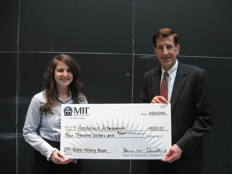 MITFCU President and CEO Brian Ducharme, right, presents the 2012 MITFCU People Helping People Award to Corinne Carland. Corinne represents the MIT service organization, Amphibious Achievement.