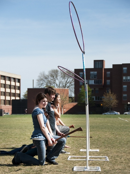 (From left) Prospective freshmen Ariella Yosafat, Alex Garzon and Annie Kuan straddle their brooms as they get ready to start a game of Quidditch organized by members of the MIT Marauders, the school's club team.