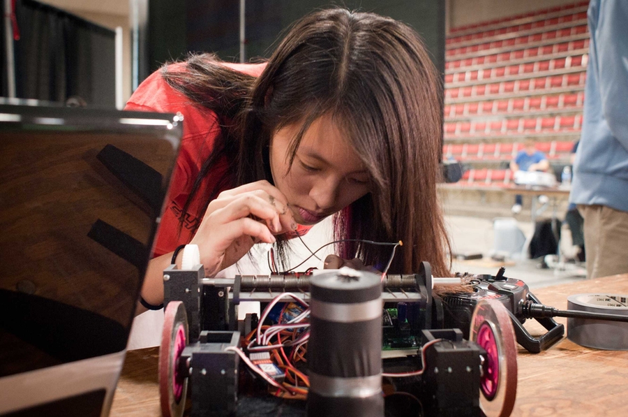A student in 2.007 makes last-minute adjustments to her robot.
