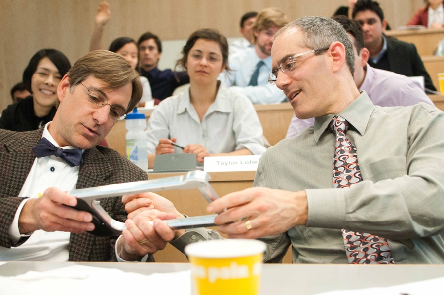 Professors Matt Kressy of the Rhode Island School of Design (RISD) and Steven Eppinger of the MIT Sloan School of Management admire an innovative bike lock designed by a team of students from MIT's Sloan School and School of Engineering and RISD.