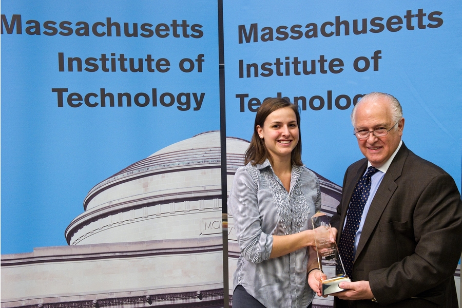 Chris Colombo, dean for student life, presents the Betsy Schumacker Award to senior Kameron Klauber.