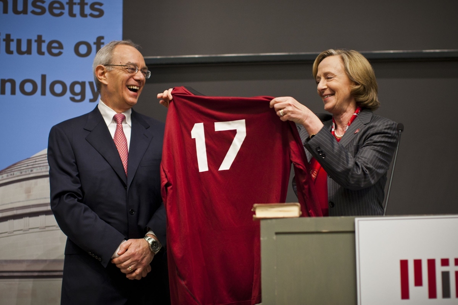 MIT's 16th president, Susan Hockfield, gives Reif gifts, including a baseball jersey with '17' on the back, at the community event.