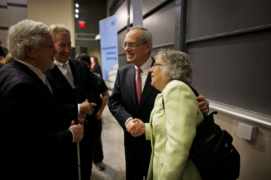 Reif talks to Cambridge Mayor Henrietta Davis, right, and other community members after the event.
