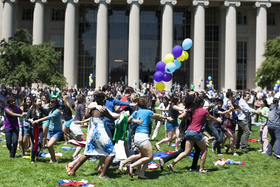 A flash mob of students ran to the center of Killian Court during the Hockfield Day celebration, waving international flags in a choreographed dance.