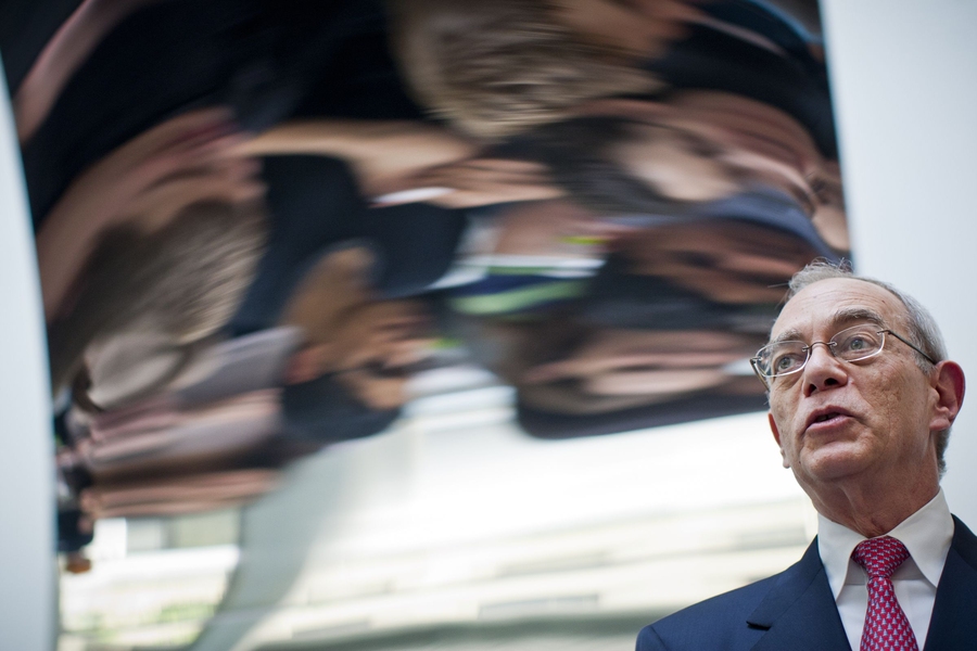 Reif addresses the crowd of students, reflected in the Kapoor sculpture.