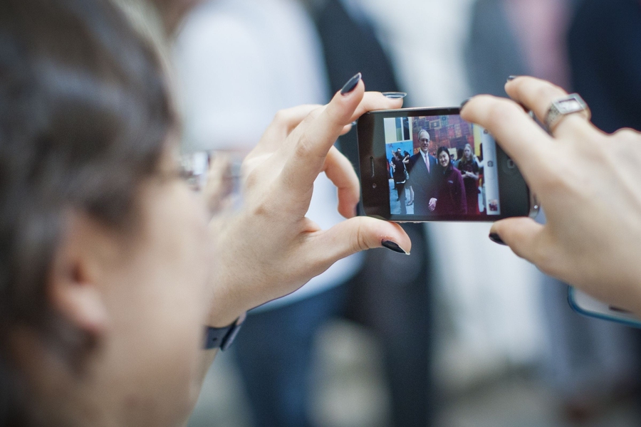 A community members takes a photo of the new president-elect.