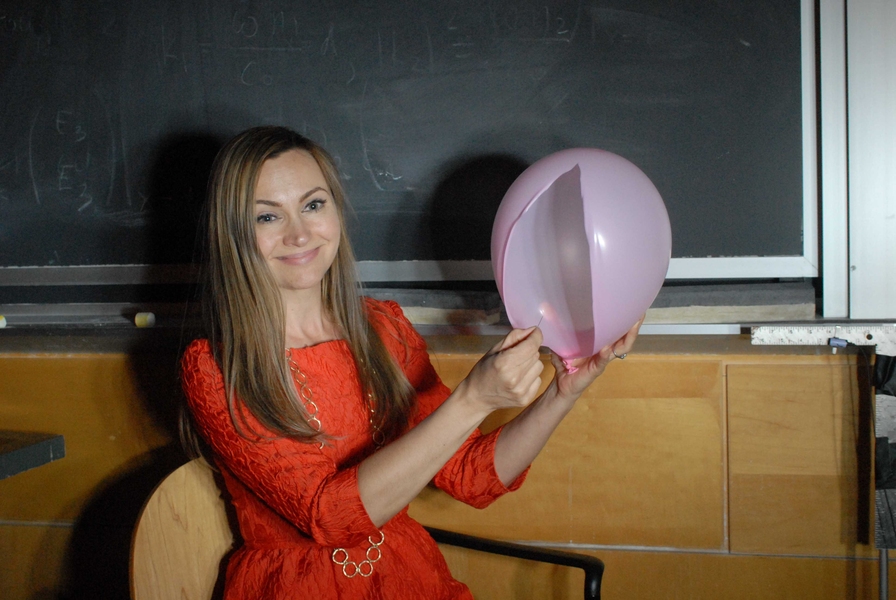 Alexandra Metral pops a balloon.
