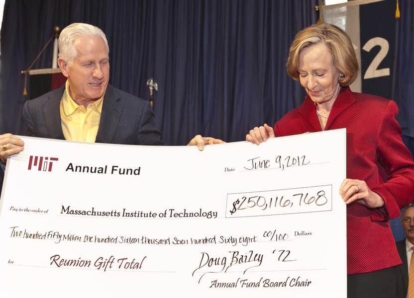 Annual Fund Board Chair Doug Bailey '72, SM '74, ME '75 presents a symbolic check to President Susan Hockfield on June 9 for record-breaking reunion giving of $250.1 million.