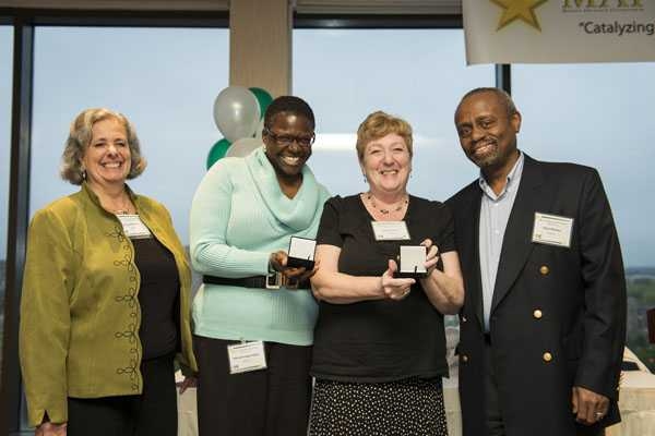 Debroah Hodges-Pabon and Sandy Tenorio (center left and right, respectively) receive the “Tungsten” Longevity Award from long time MAP mentors Bonny Kellermann, left, and Sekazi Mtingwa, right.