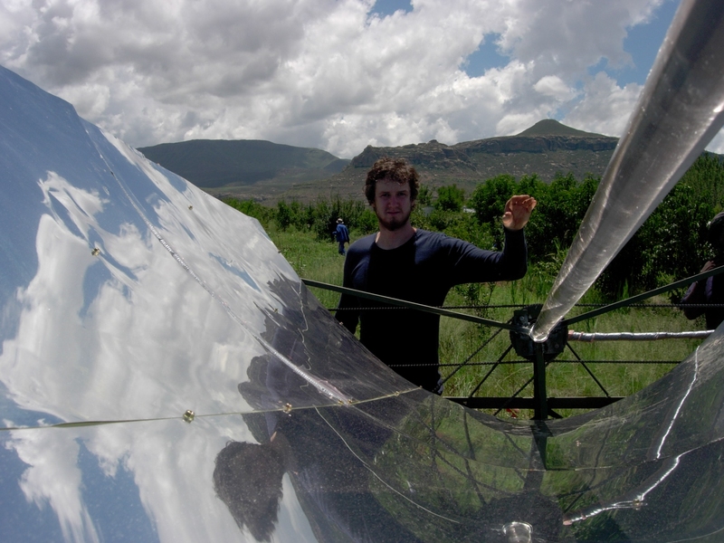 Matthew Orosz stands with a parabolic solar collector in Lesotho in January 2006. During this trip, funded by IDEAS awards and Public Service Center fellowships, Orosz and his team deployed their second field prototype.
