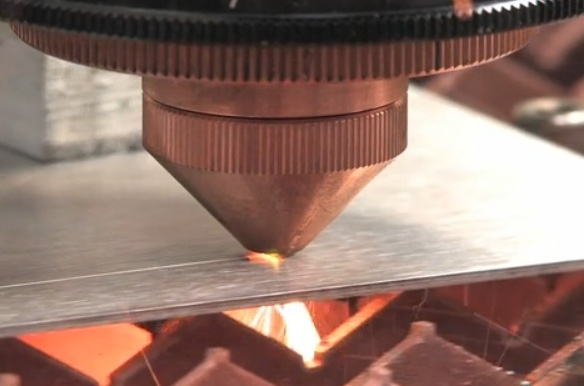 The wavelength beam-combining diode laser is shown cutting through several millimeters of steel. A small spot size combined with high intensity provides high-speed cuts through thick materials with minimal impairment to the width of the cut. 