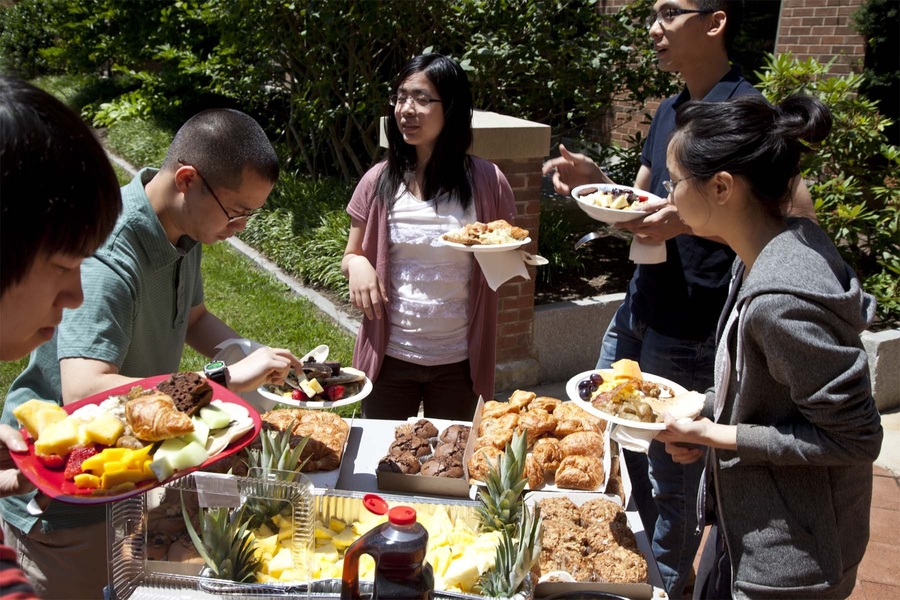 Graduate students fill their plates for a delicious brunch served in the Sidney Pacific courtyard as part of the graduate dormitory’s 10th Anniversary Reunion.