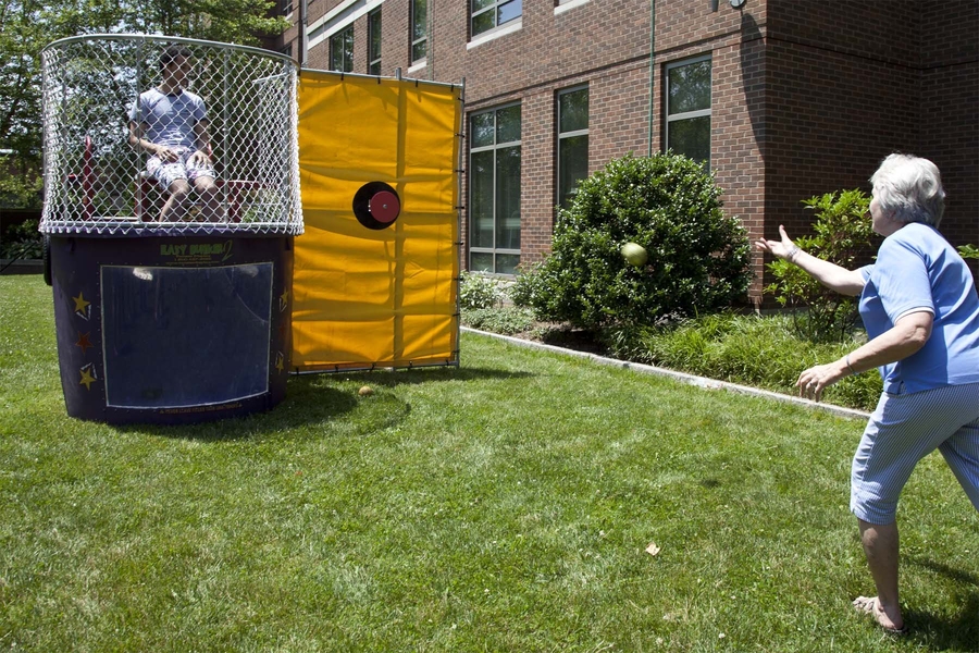 Sidney-Pacific Housemaster Dottie Mark takes aim at Ahmed Helal G, who is waiting anxiously in the dunk tank.