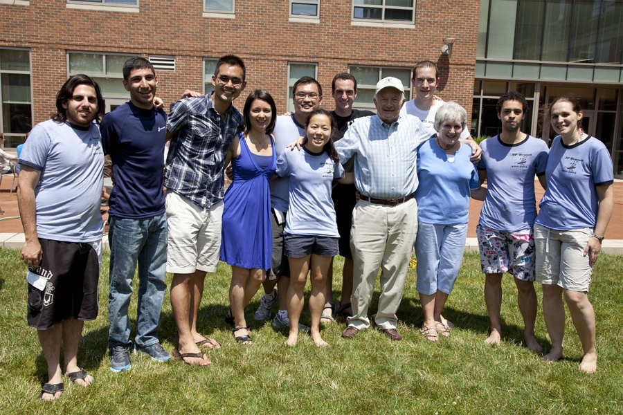 Sidney-Pacific residents pose with Housemasters Roger and Dottie Mark during the 10th Anniversary Brunch and Carnival (L-R: Fabián Kozynski G, Armen Mkrtchyan G, Michael Peng G, Michelle Sander PhD '12, Jit Hin Tan G, Chelsea He G, David Rosen G, Roger Mark '60 & PhD '66, Tim Curran G, Dottie Mark, Ahmed Helal G, Amy Bilton G).
