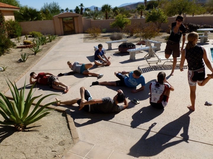 The team's demanding training regimen means that rest and recovery is also vital for peak performance. Here, Juls Andren leads a stretching session for his teammates at training camp in California.