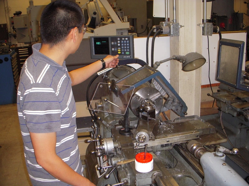 Anthony Wong, a graduate student in Course 2, turns a bushing in the lathe to be used is one of his experiments for his research based on hydrostatic bearings. The Student Shop provides training in the use of machine tools, access to them, and guidance in project planning. Students log more than 3,000 hours annually working on course and research-related projects. The mix of manual and state of th...