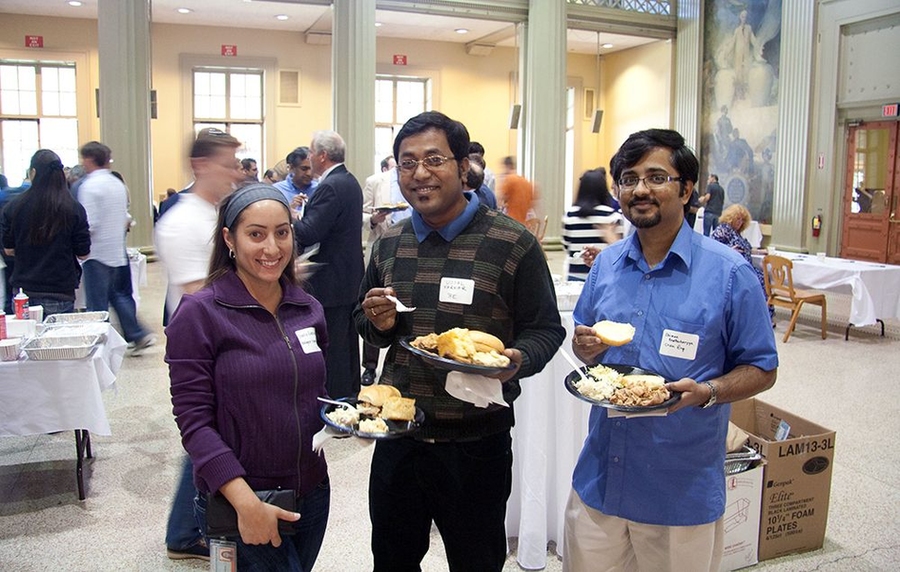 A few postdocs socialize during an event in Walker Memorial.