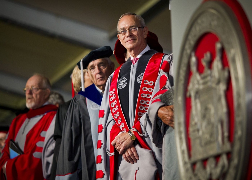 Reif stands on stage next to former MIT Corporation Chairman Dana Mead, center, and Chaplain to the Institute Robert Randolph.