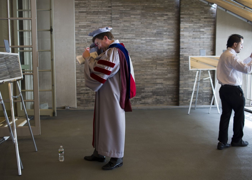 Members of the procession get ready prior to marching into Killian Court.