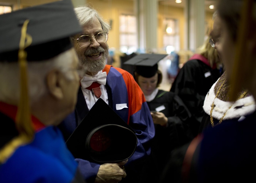 Members of the procession get ready prior to marching into Killian Court.