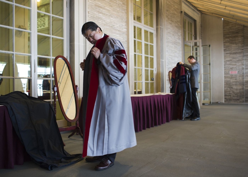 Members of the procession get ready prior to marching into Killian Court.